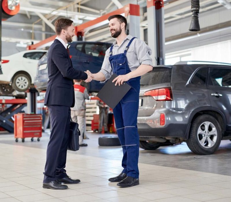 worker-shaking-hands-with-client-in-car-service-sh-small-1024x682-1.jpg